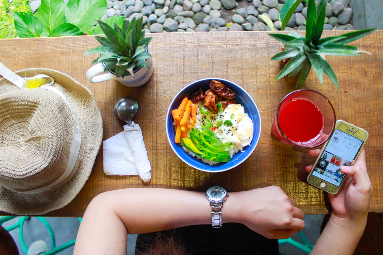 our-services-02 Fresh and healthy bowl meal with juice and smartphone on a wooden table, perfect for lifestyle and food photography.